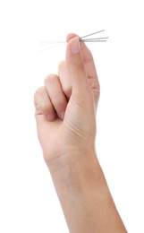 Photo of Woman holding acupuncture needles on white background