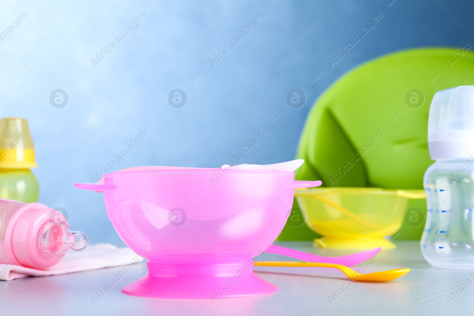 Photo of Bright child's dishware on grey table indoors