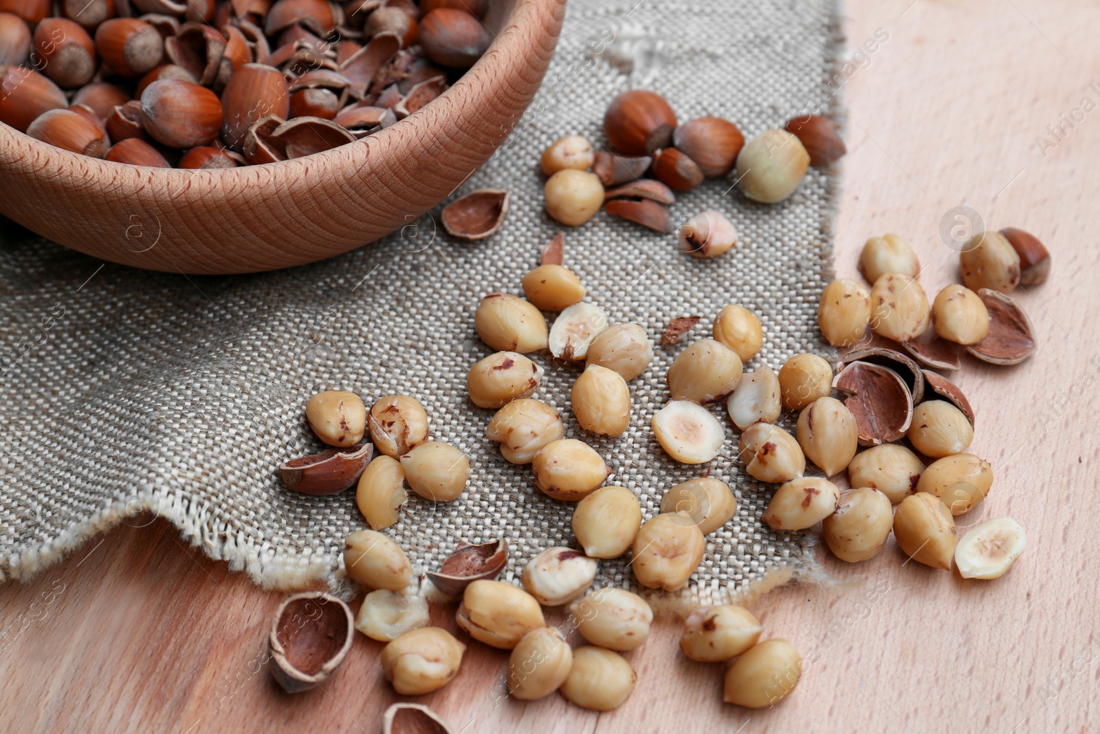 Photo of Tasty organic hazelnuts on wooden table. Healthy snack