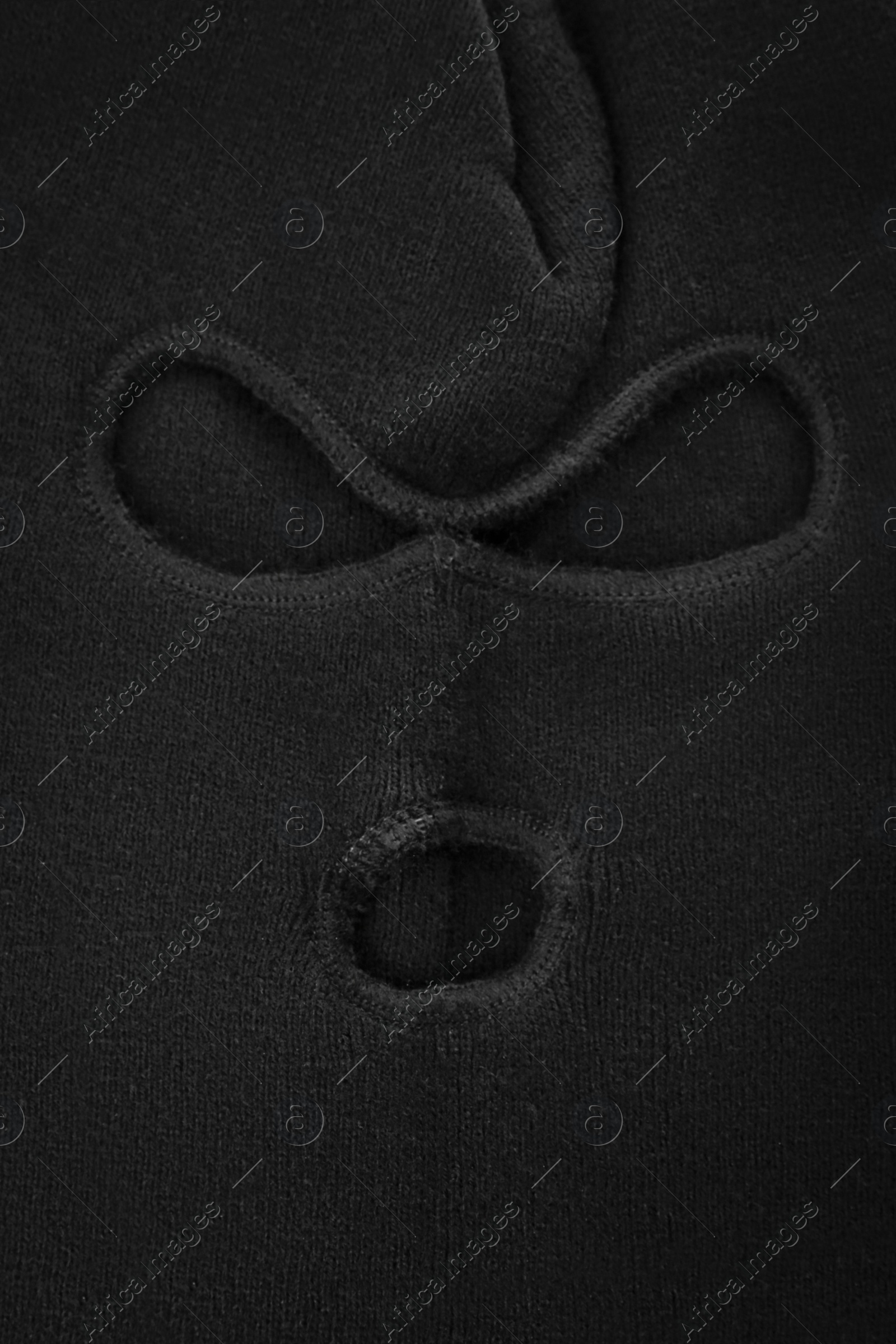 Photo of Black knitted balaclava as background, closeup view