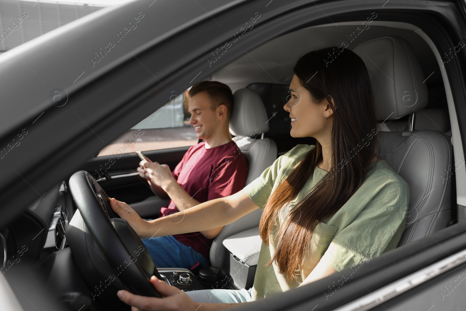 Photo of Happy young couple travelling together by car