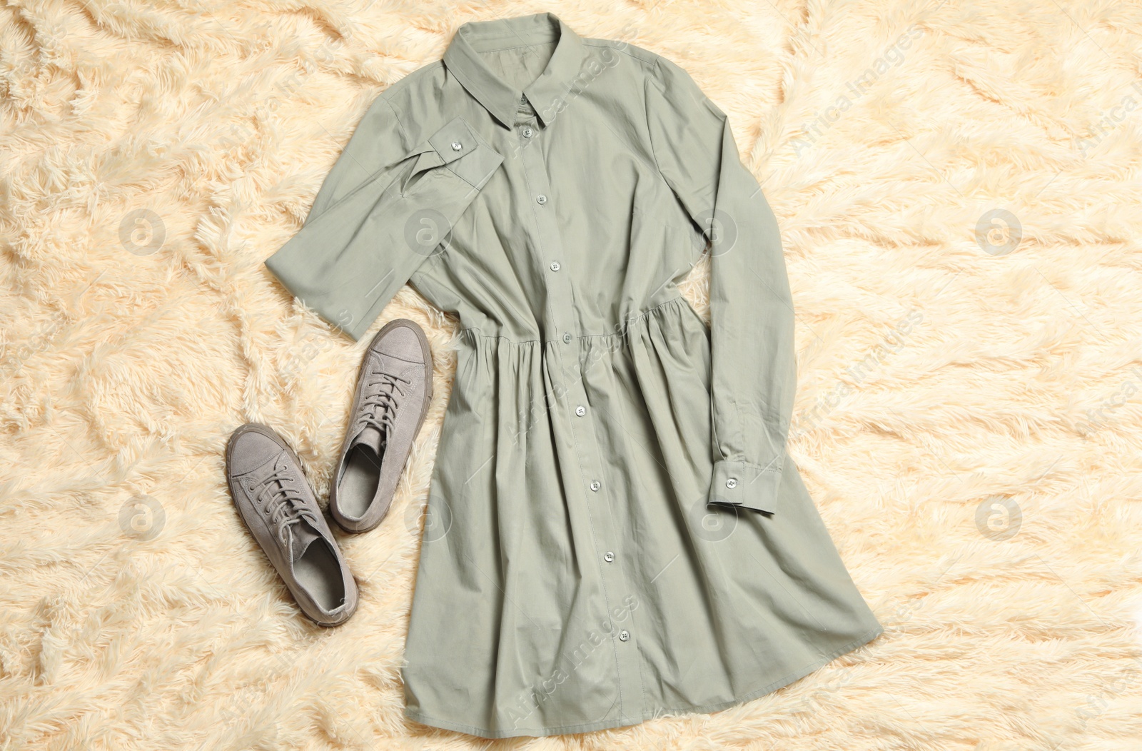 Photo of Stylish grey dress and shoes on beige blanket, flat lay