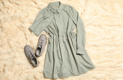 Stylish grey dress and shoes on beige blanket, flat lay