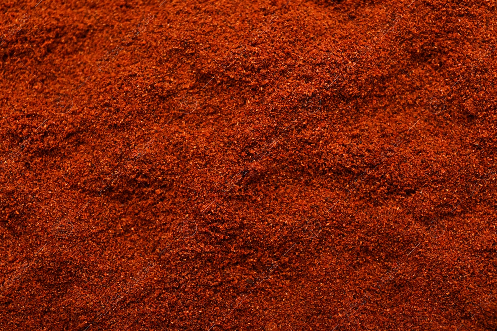 Photo of Aromatic paprika powder as background, top view