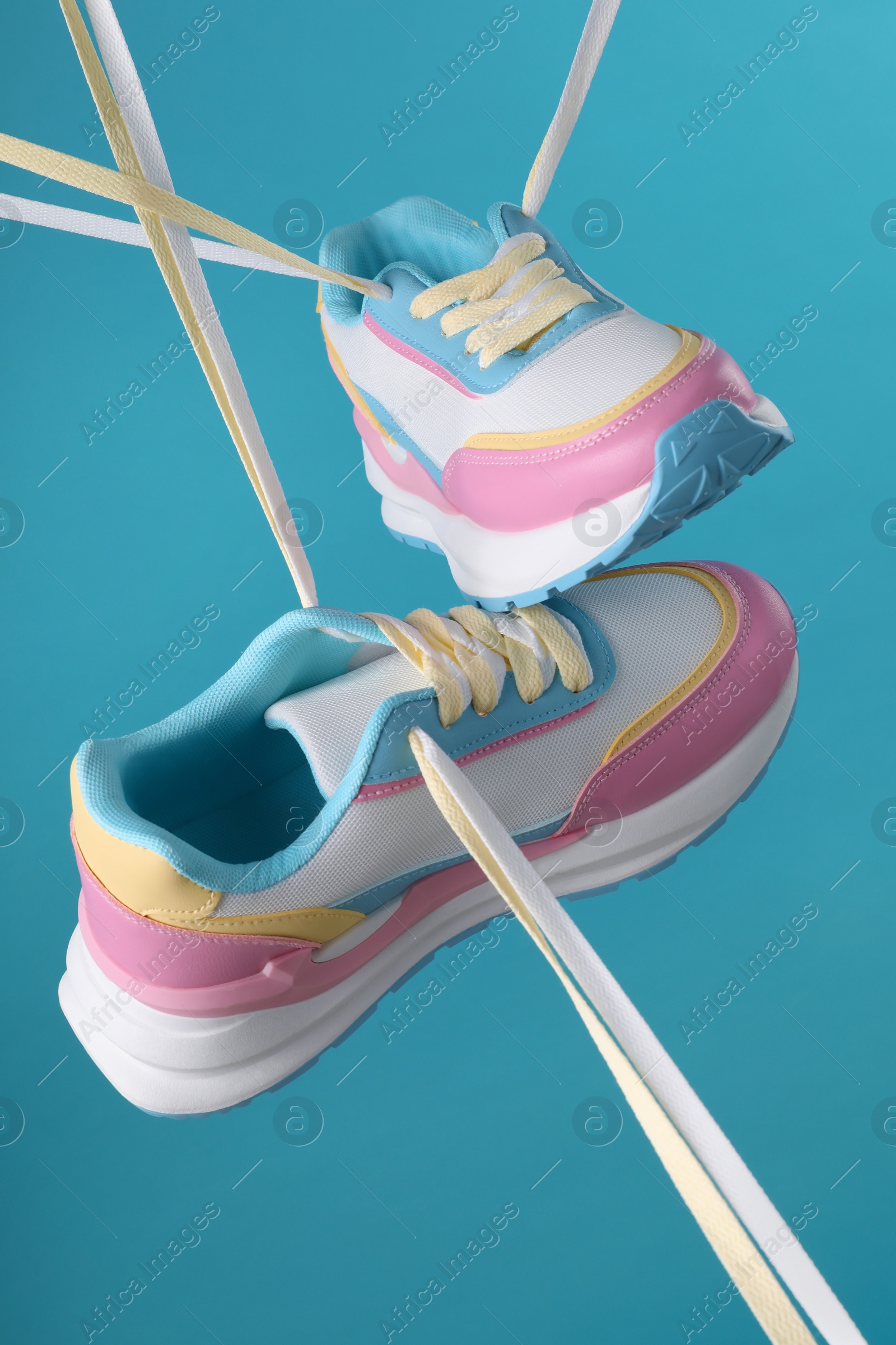 Photo of Pair of stylish sneakers on light blue background