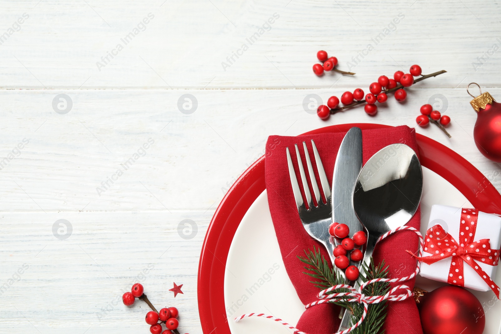 Photo of Beautiful Christmas table setting and festive decor on white wooden background, flat lay. Space for text