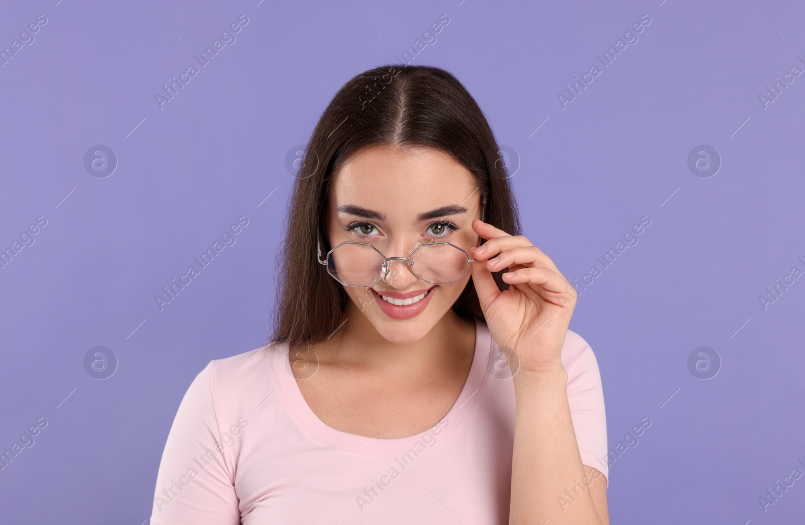 Photo of Beautiful woman wearing glasses on violet background