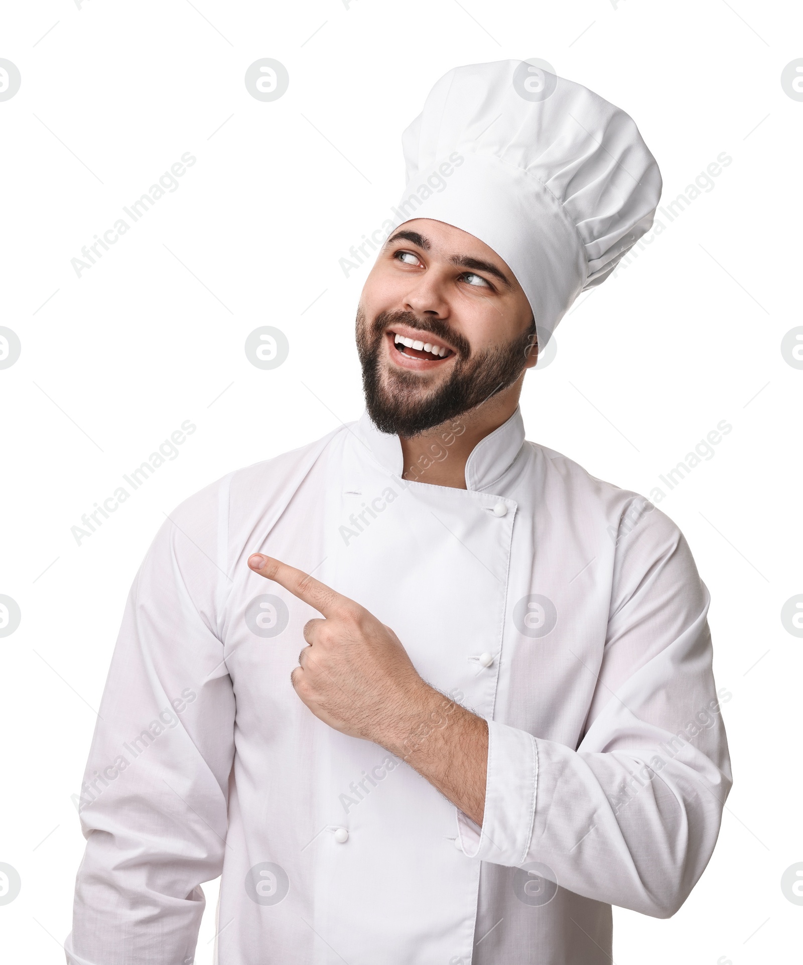 Photo of Happy young chef in uniform pointing at something on white background