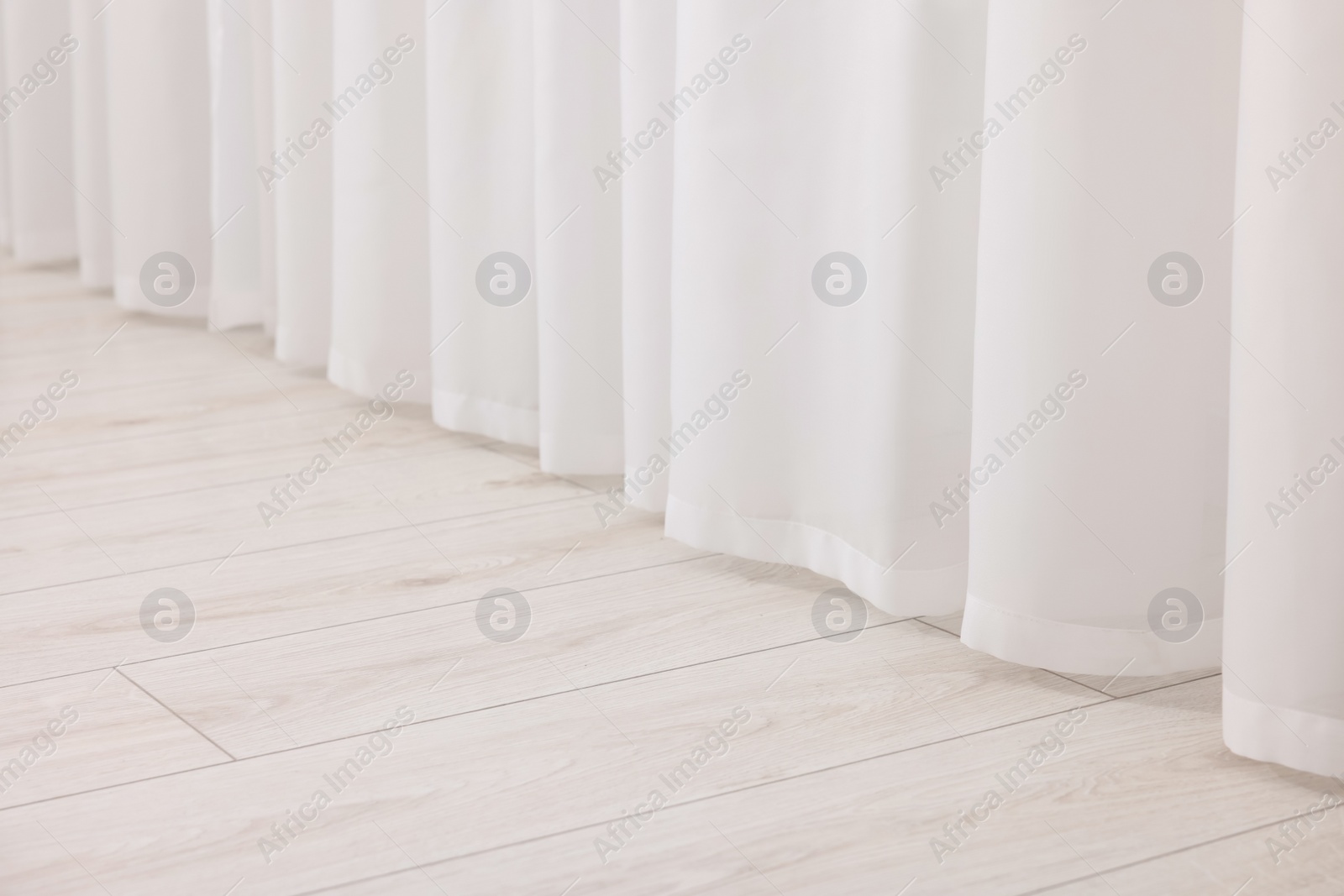 Photo of Beautiful white window curtains indoors, closeup view