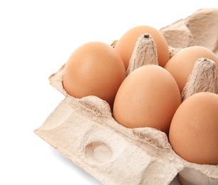 Carton of raw chicken eggs on white background