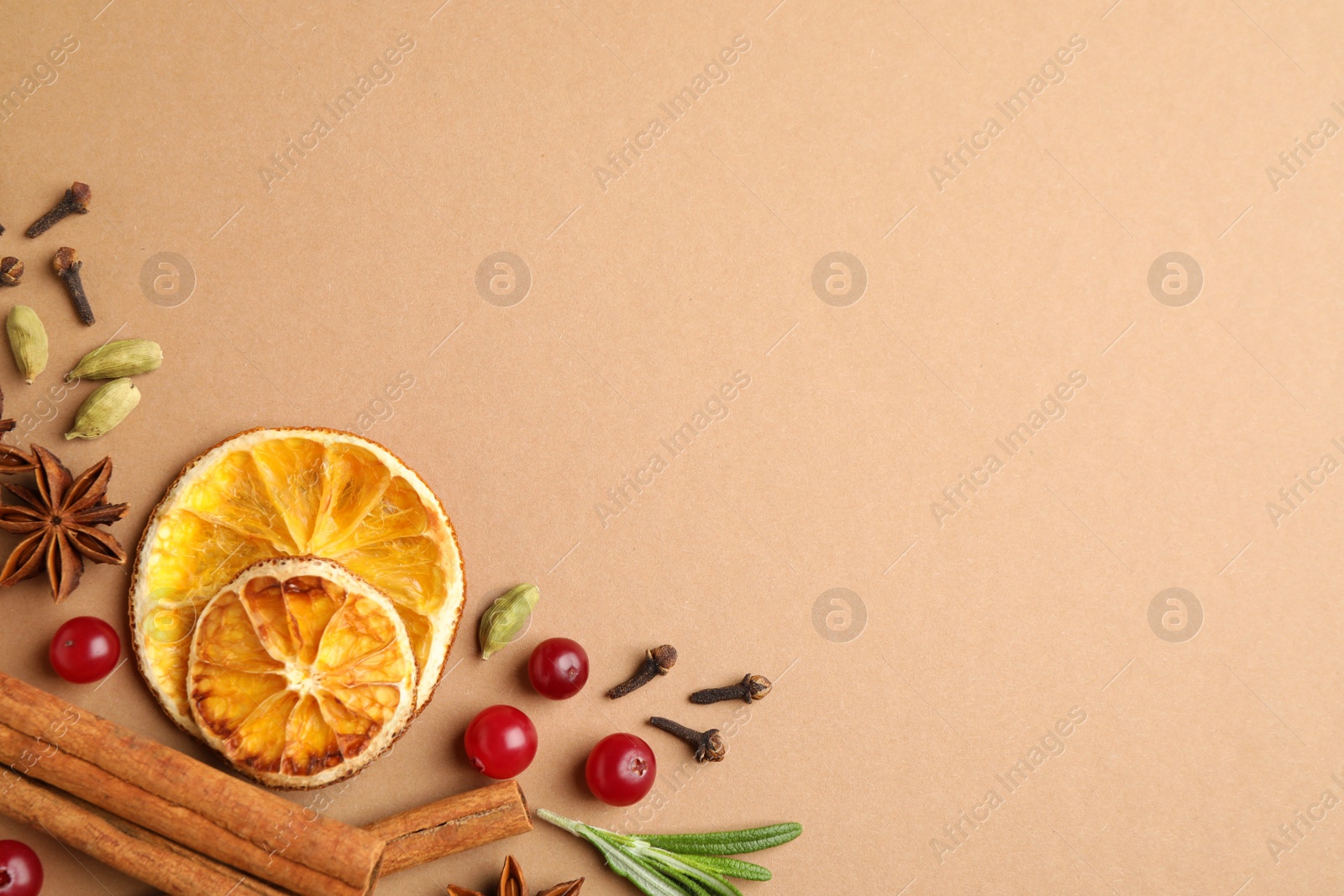 Photo of Different mulled wine ingredients on brown background, flat lay. Space for text