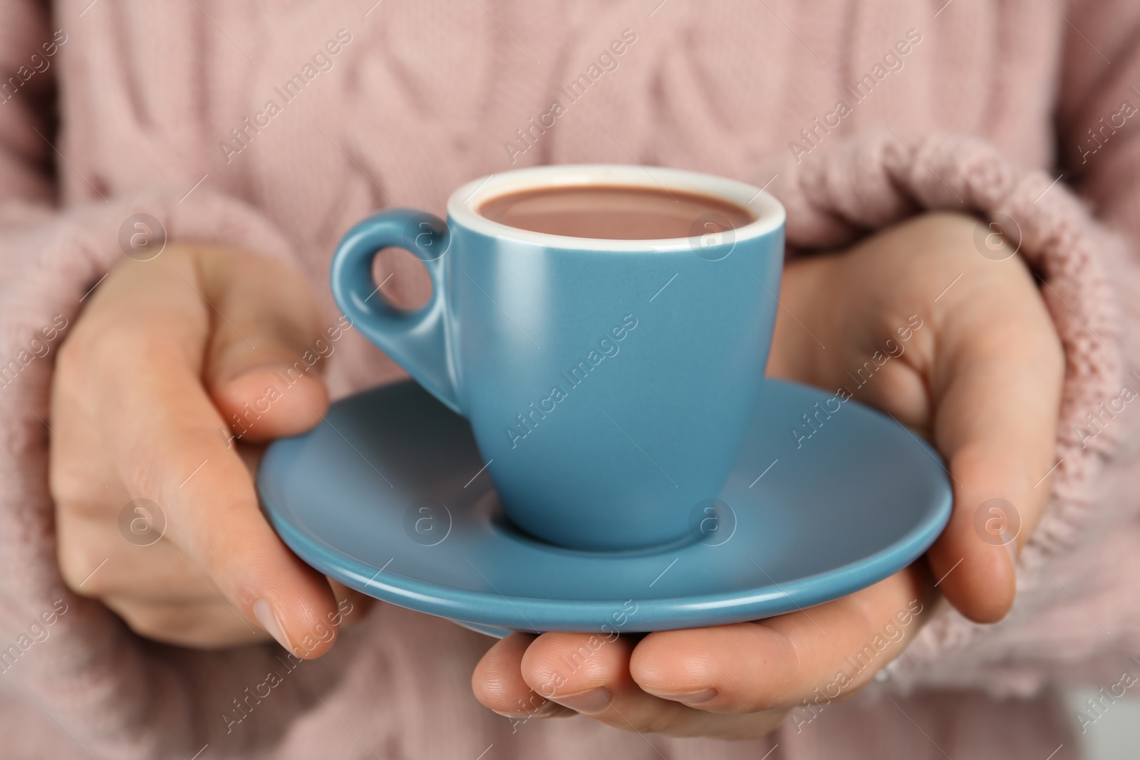 Photo of Woman holding cup of delicious hot chocolate, closeup
