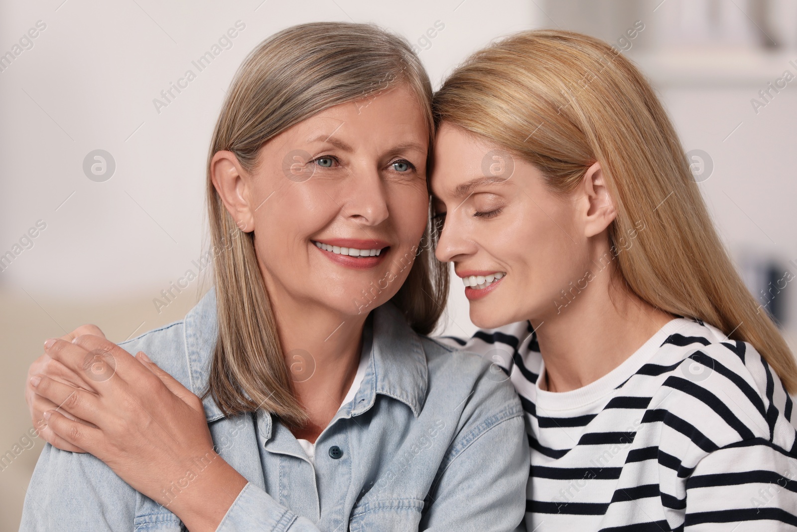 Photo of Happy daughter and her mature mother indoors