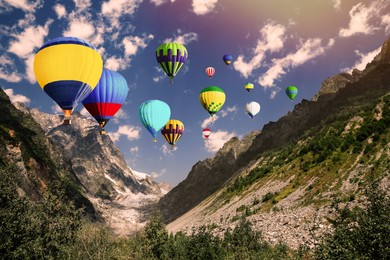 Bright hot air balloons flying over mountains