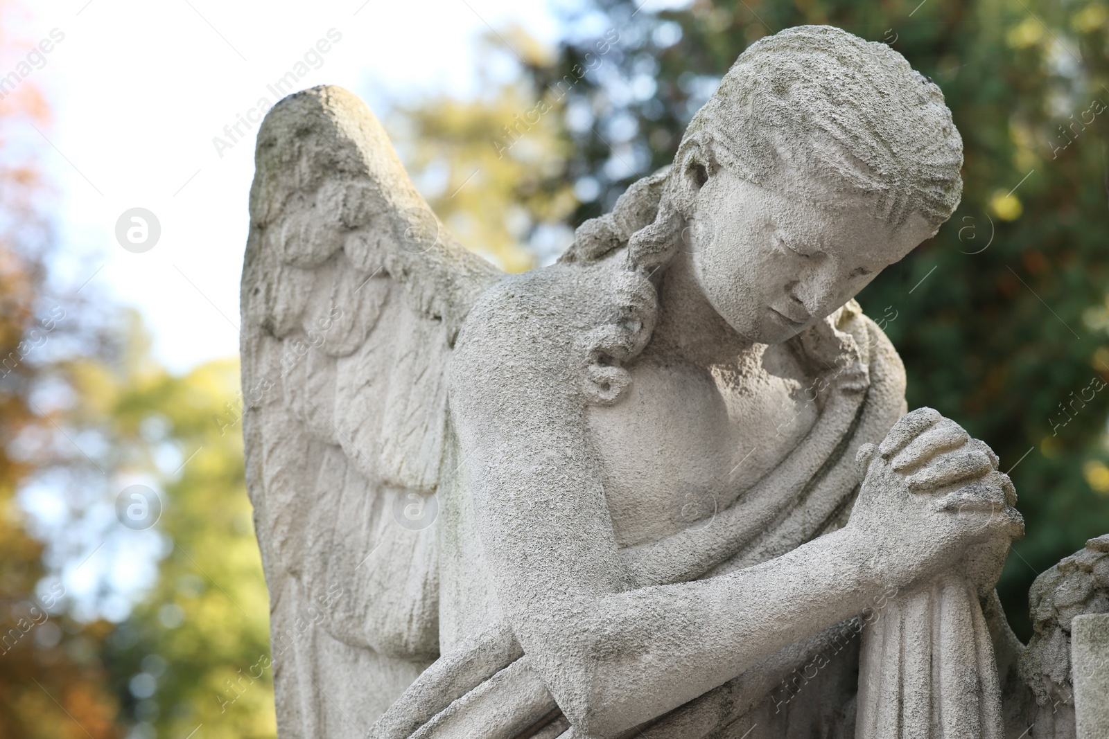 Photo of Beautiful statue of angel at cemetery. Religious symbol