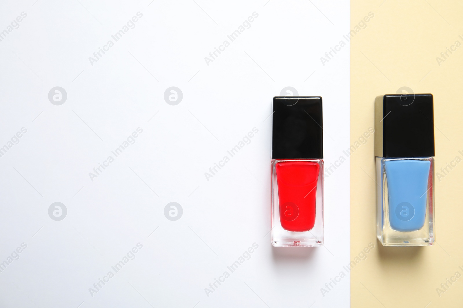 Photo of Bottles of nail polish on color background, top view with space for text