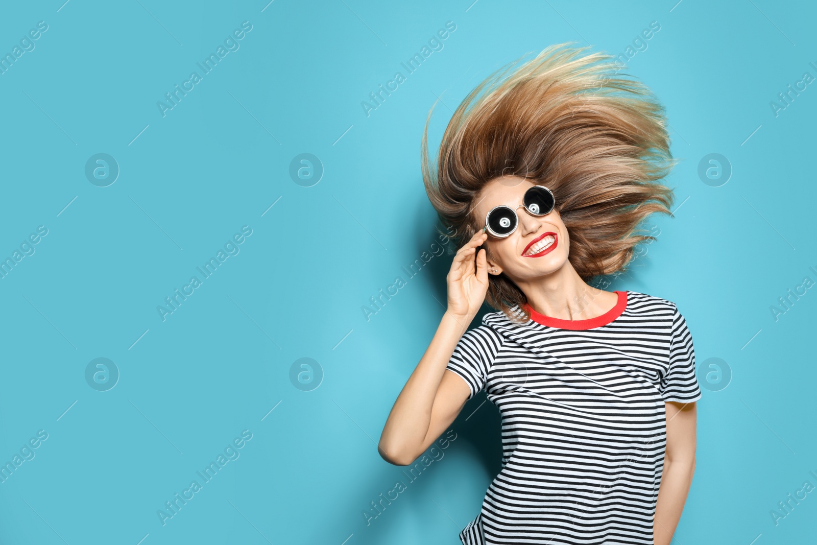 Photo of Beautiful young woman with healthy long blonde hair on color background. Space for text