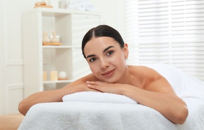 Beautiful young woman relaxing in spa salon