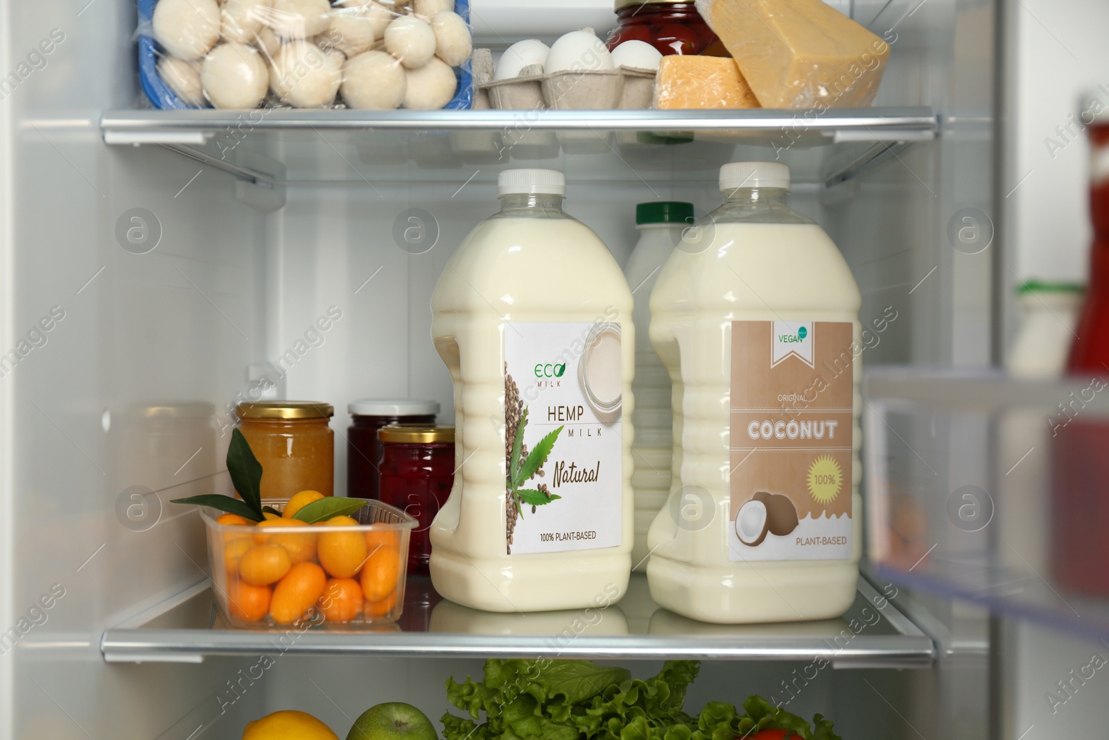 Image of Gallons of hemp and coconut milk a in refrigerator. Vegan product