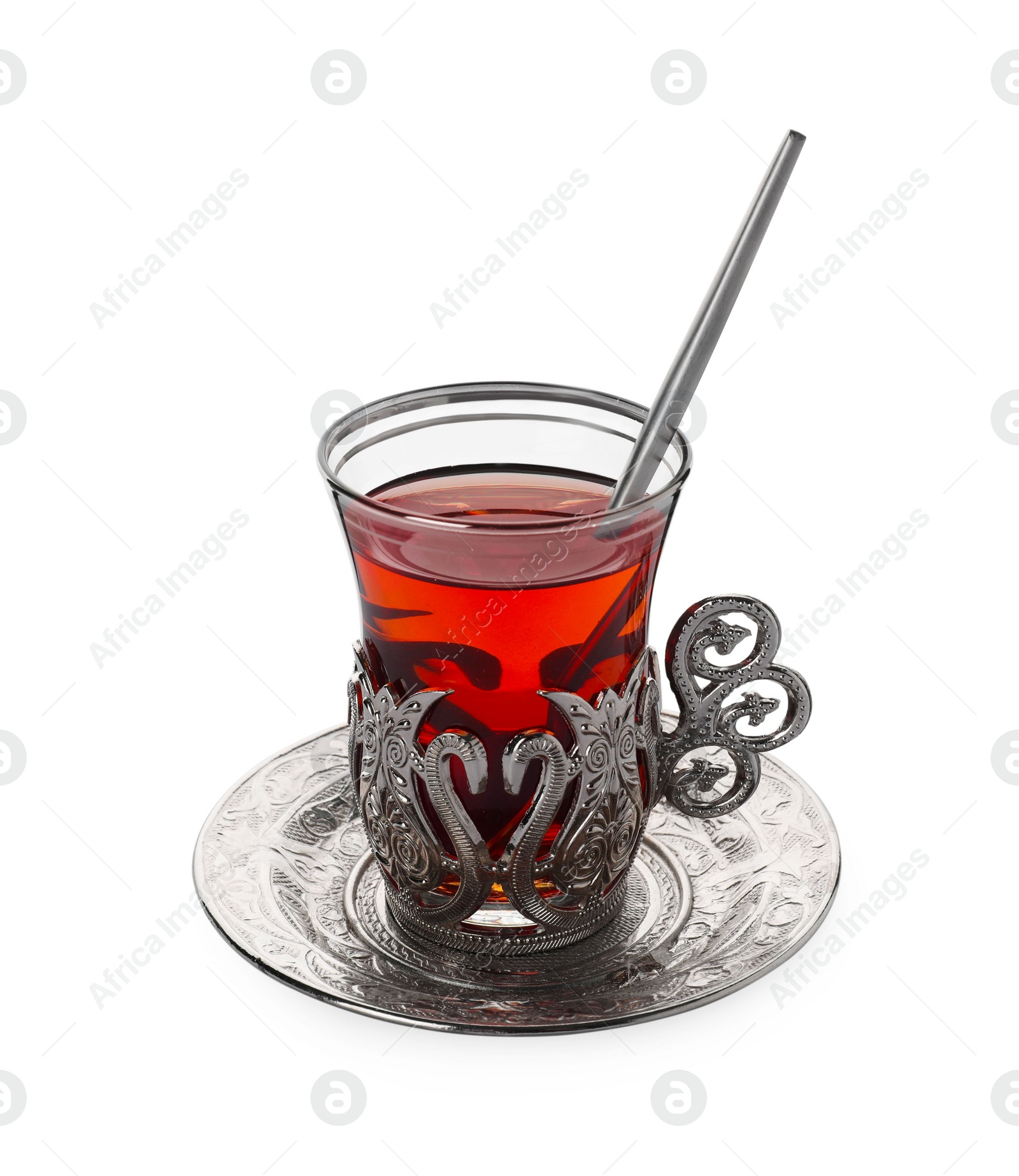 Photo of Glass of traditional Turkish tea in vintage holder isolated on white