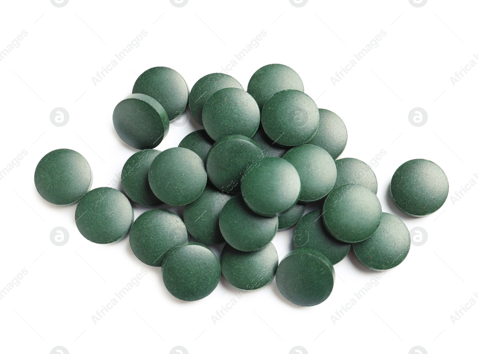 Photo of Heap of spirulina tablets on white background, top view