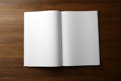 Open blank paper brochure on wooden table, top view. Mockup for design