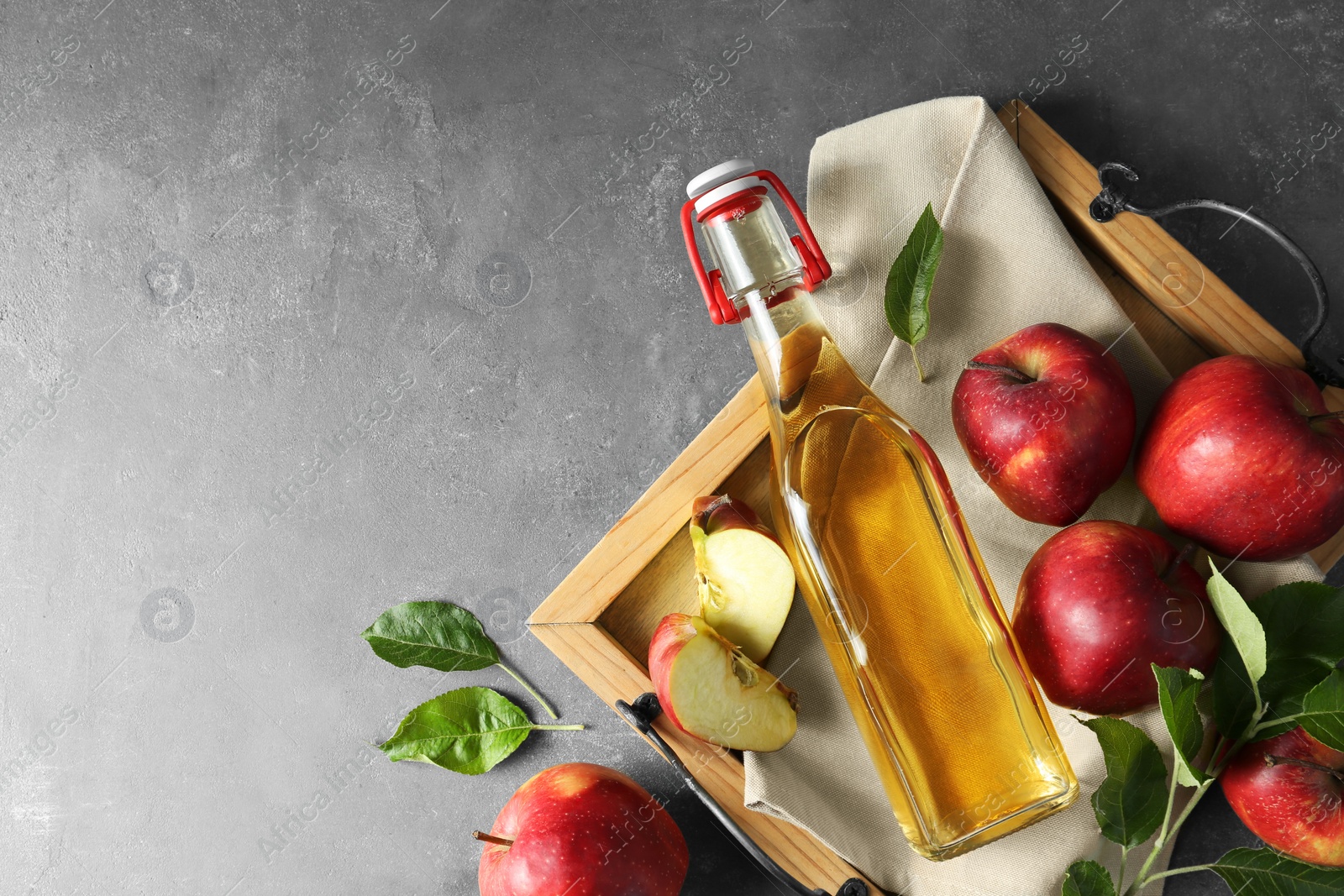 Photo of Flat lay composition with delicious apple cider on gray table, space for text