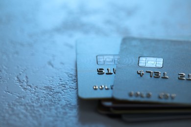 Plastic credit cards on table, closeup view. Space for text