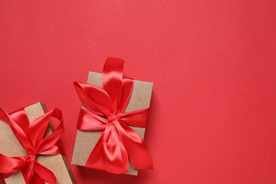 Beautiful gift boxes on red background, flat lay. Space for text