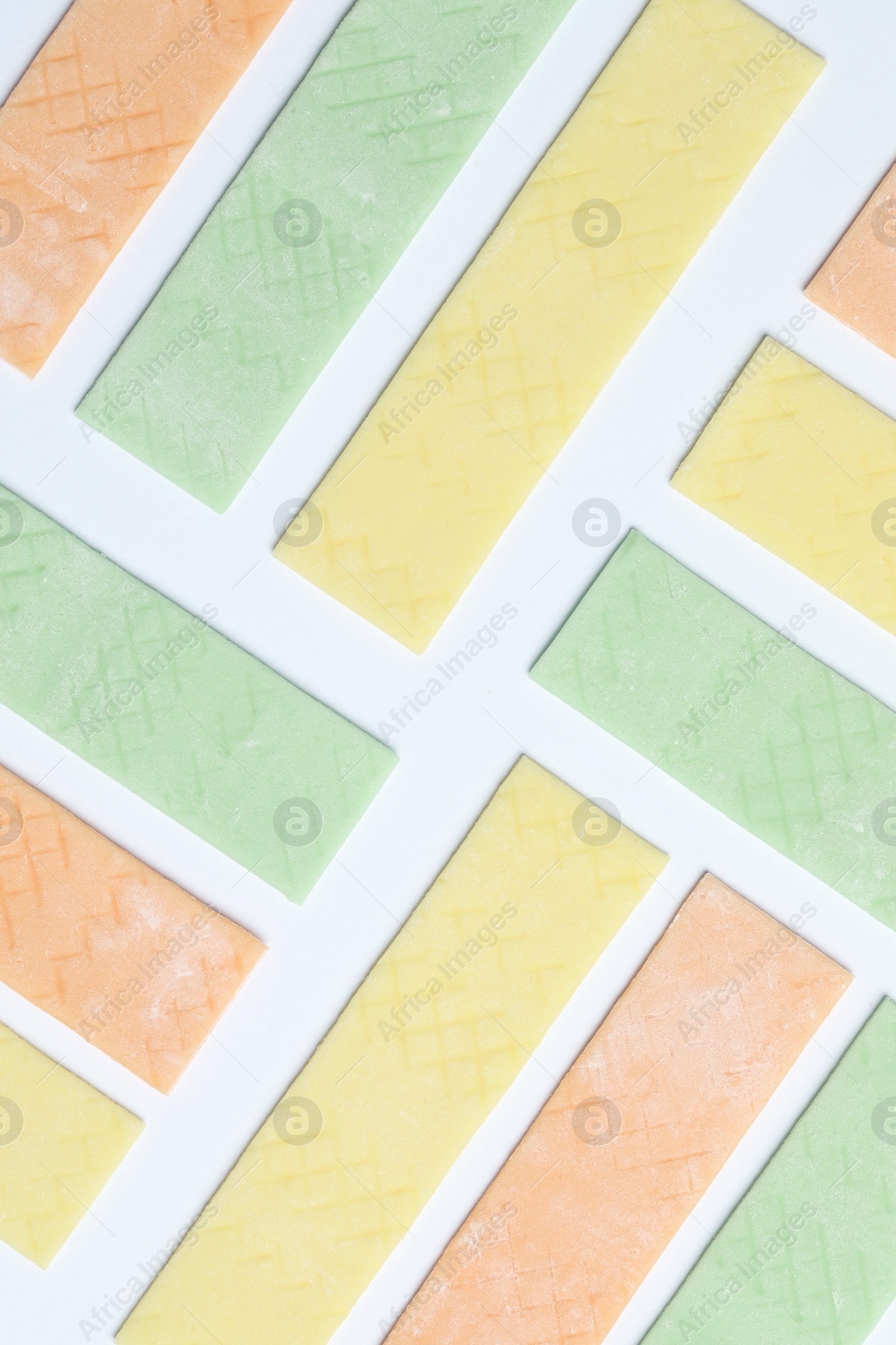 Photo of Sticks of tasty bubble gums on white background, flat lay