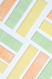 Photo of Sticks of tasty bubble gums on white background, flat lay