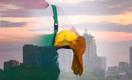 Image of Double exposure of engineer and cityscape in evening