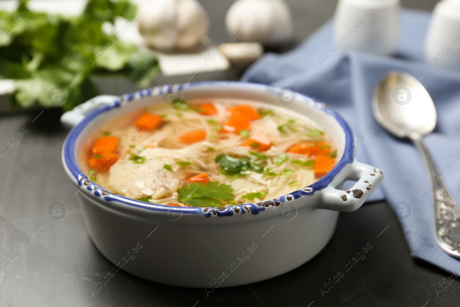 Photo of Dish with fresh homemade chicken soup on table