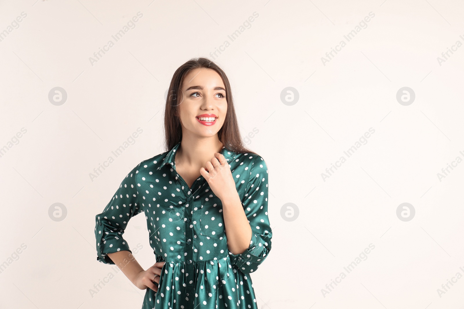 Photo of Portrait of beautiful young woman in stylish dress on white background. Space for text