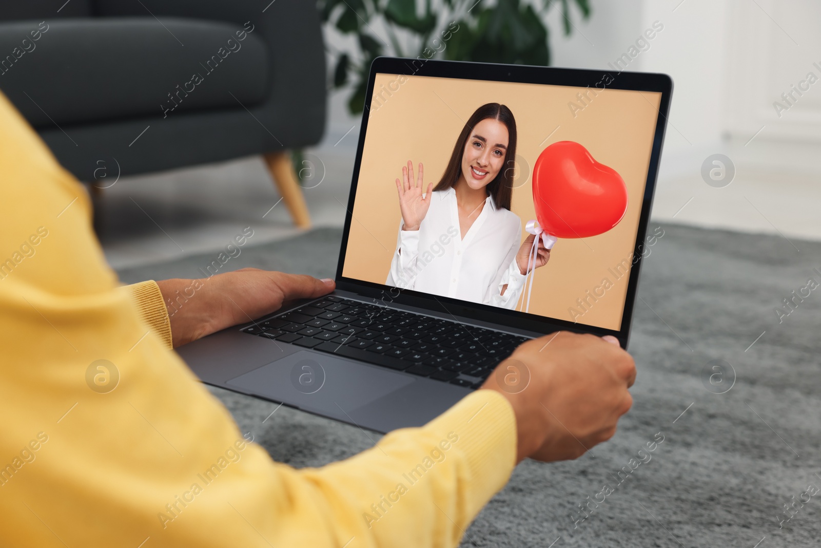 Image of Long distance love. Man having video chat with his girlfriend via laptop at home, closeup