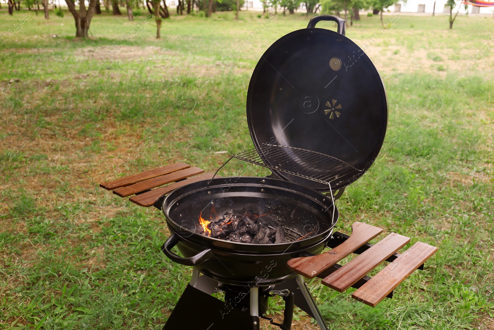 Photo of New modern barbecue grill outdoors. Summer picnic