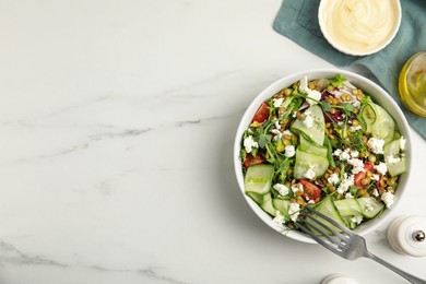 Delicious salad with lentils, vegetables and feta cheese served on white table, flat lay. Space for text