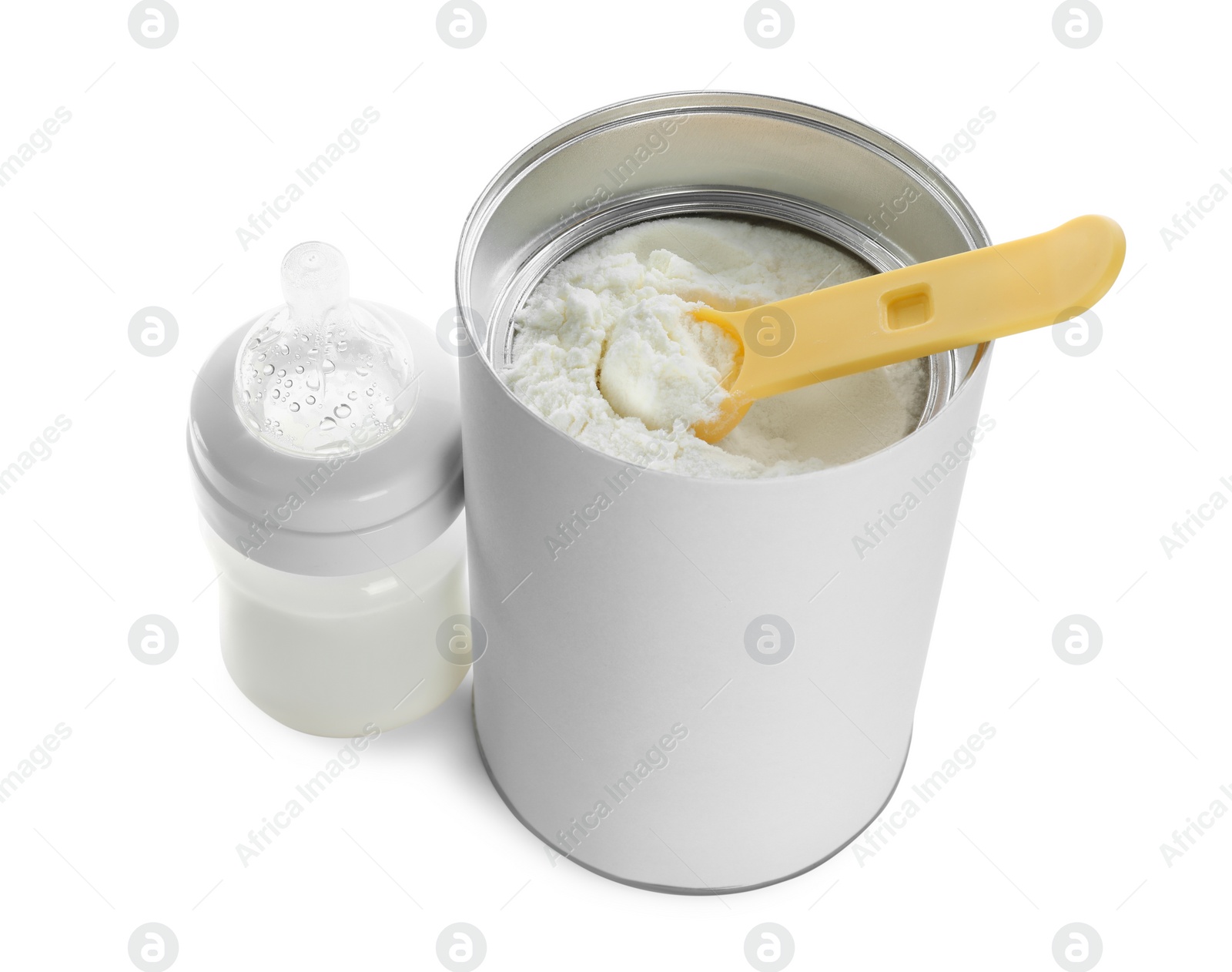 Photo of Blank can of powdered infant formula with feeding bottle and scoop on white background. Baby milk