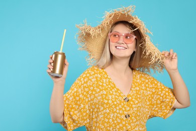 Photo of Beautiful happy woman holding beverage can on light blue background