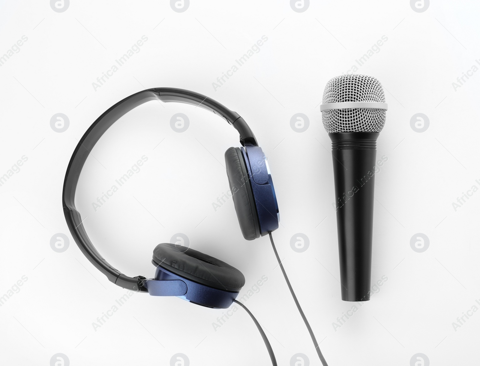 Photo of Microphone with headphones on white background, top view