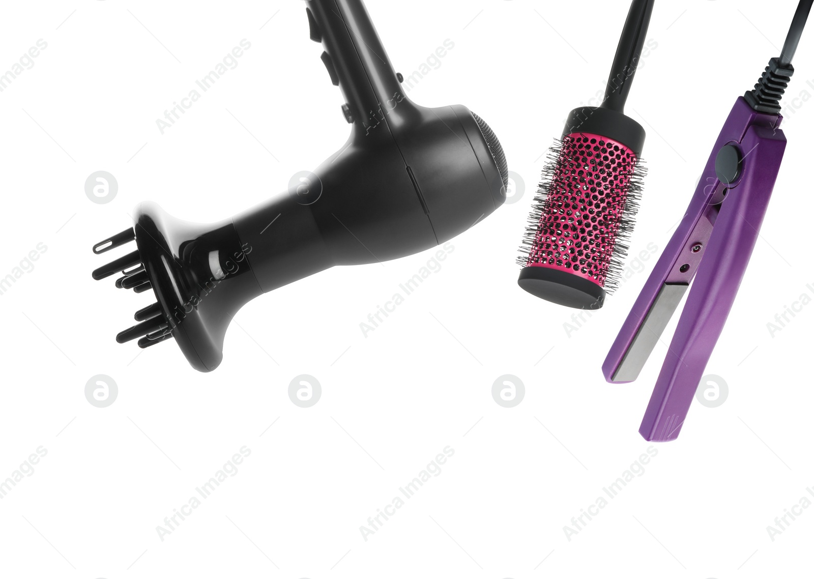 Image of Hair dryer, straightener and round brush on white background