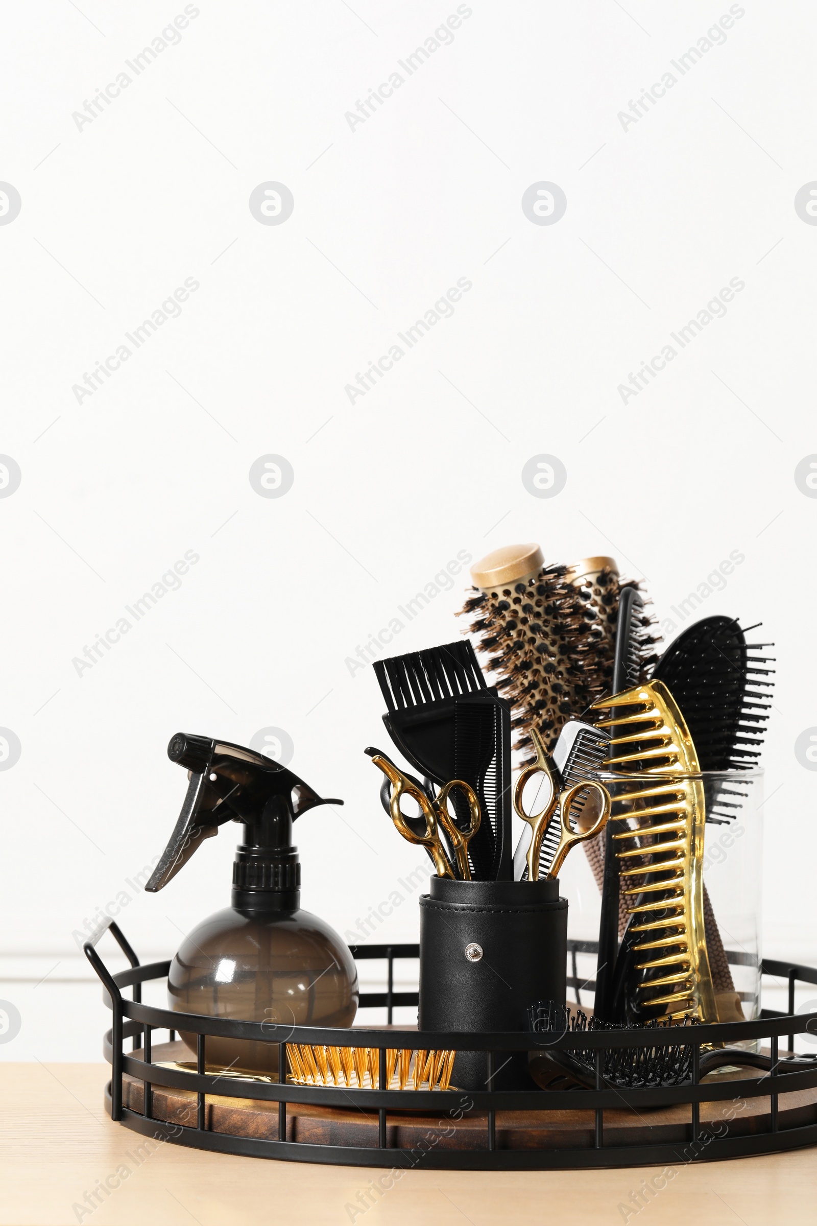 Photo of Set of hairdresser tools on table in salon