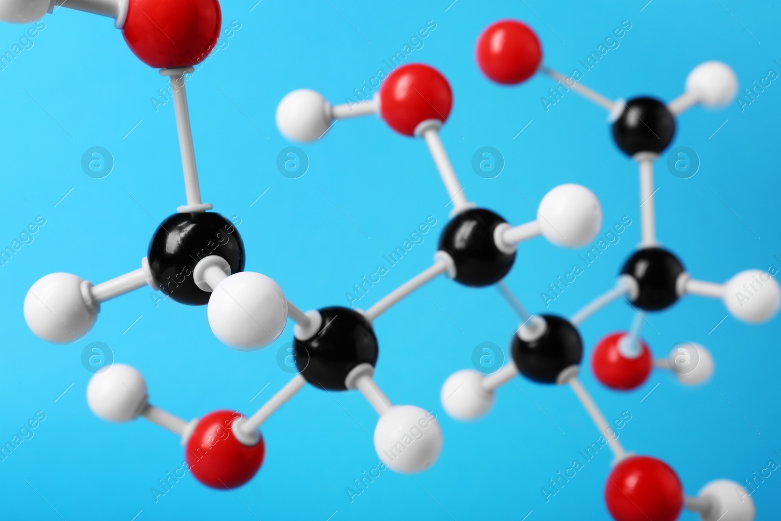 Photo of Molecule of glucose on light blue background, closeup. Chemical model