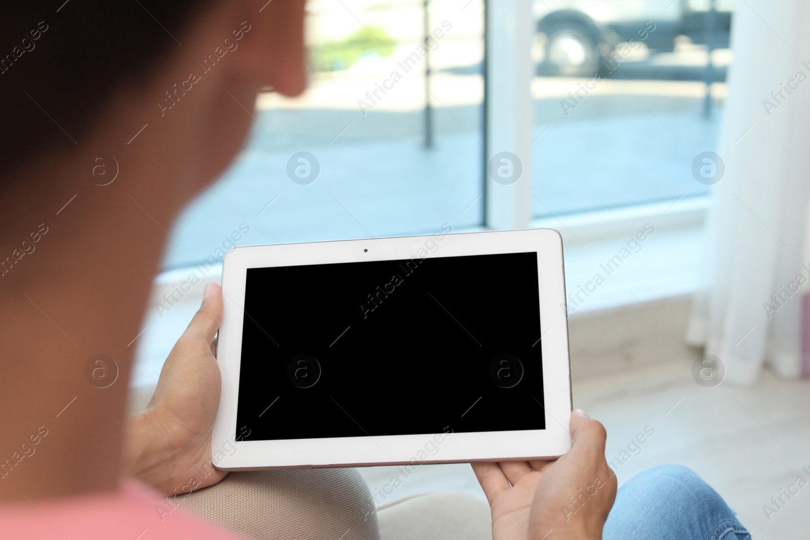 Photo of Man with modern tablet at home, closeup