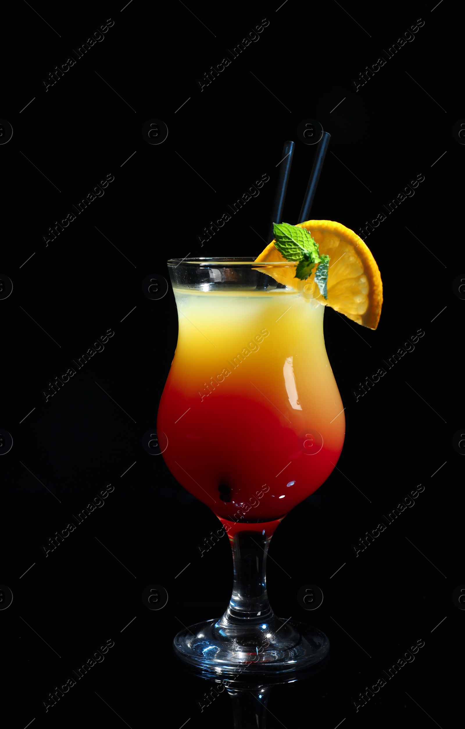 Photo of Glass of delicious cocktail Sex on the Beach decorated with orange and mint against black background