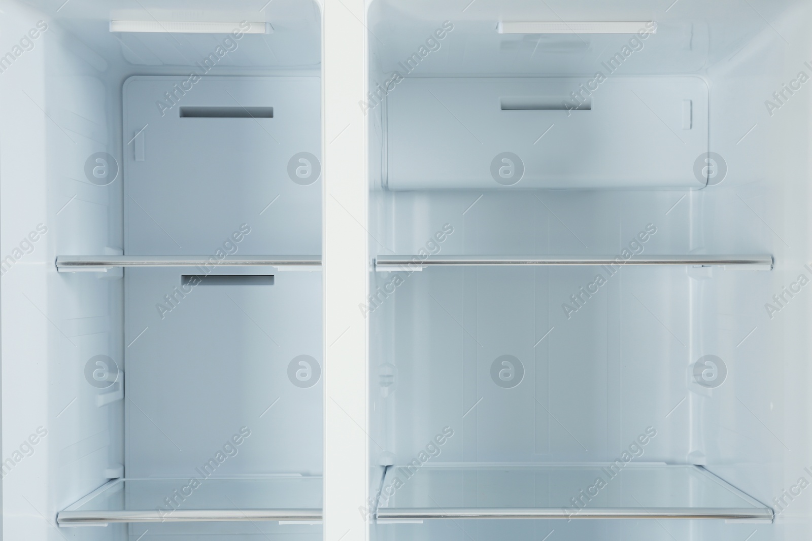 Photo of Shelves of empty modern refrigerator, closeup view