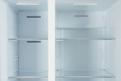 Photo of Shelves of empty modern refrigerator, closeup view
