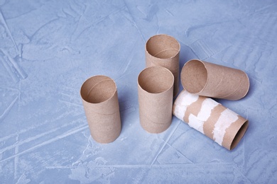 Photo of Empty toilet paper rolls on color background