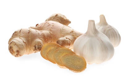 Photo of Ginger and fresh garlic on white background. Natural cold remedies