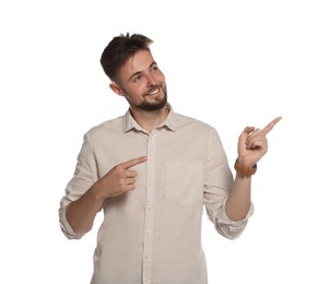 Handsome young man gesturing on white background